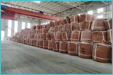 Stacked reusable FIBC bulk bags in a warehouse, designed for long-term durability and efficient bulk material storage.
