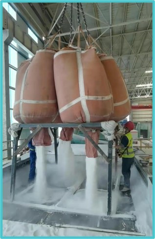 Reusable FIBC bulk bags being discharged for efficient bulk material handling.