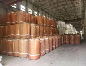 Large warehouse storing bespoke reusable FIBC bulk bags, designed for durability and multiple uses.
